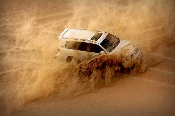 Experience the rush of sand dune bashing in the Dubai desert where golden sands and dusky skies create a backdrop for adventure and unforgettable memories.
